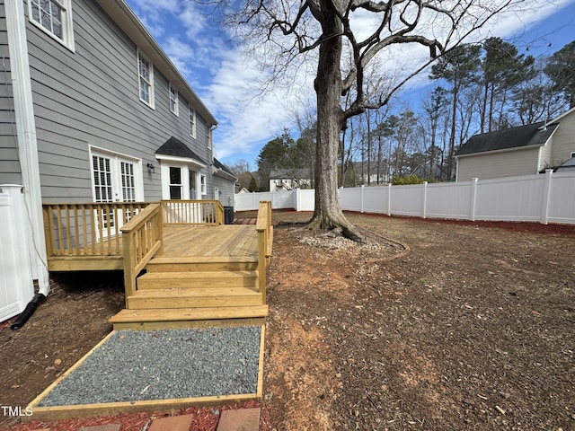 view of yard with a fenced backyard and a wooden deck