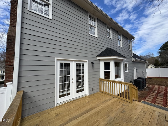 wooden deck featuring french doors, fence, and central air condition unit