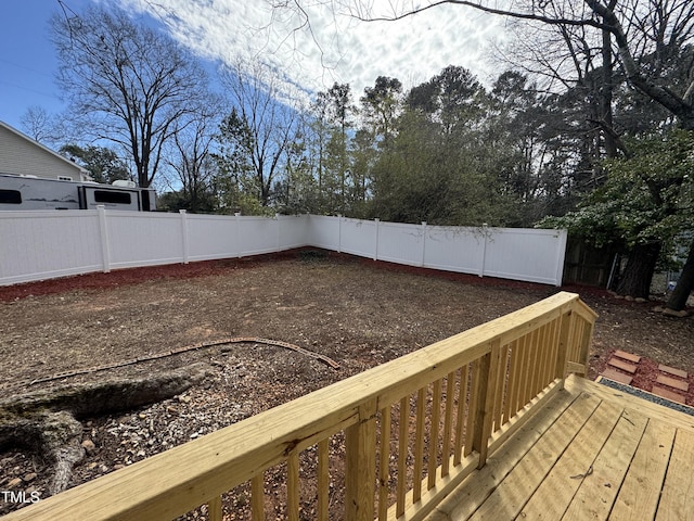 wooden deck with a fenced backyard