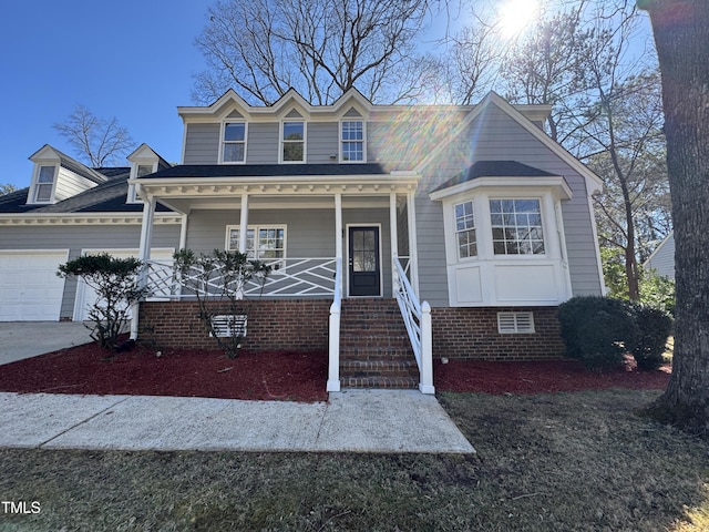 view of front of house featuring crawl space, a garage, and a porch