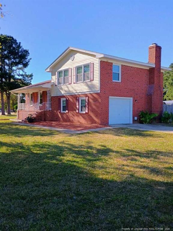 view of front of home featuring covered porch, brick siding, a front yard, and a garage