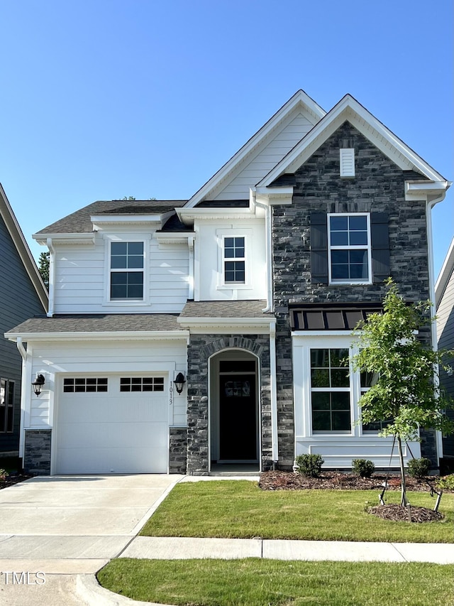 view of front of property featuring a garage, stone siding, and concrete driveway