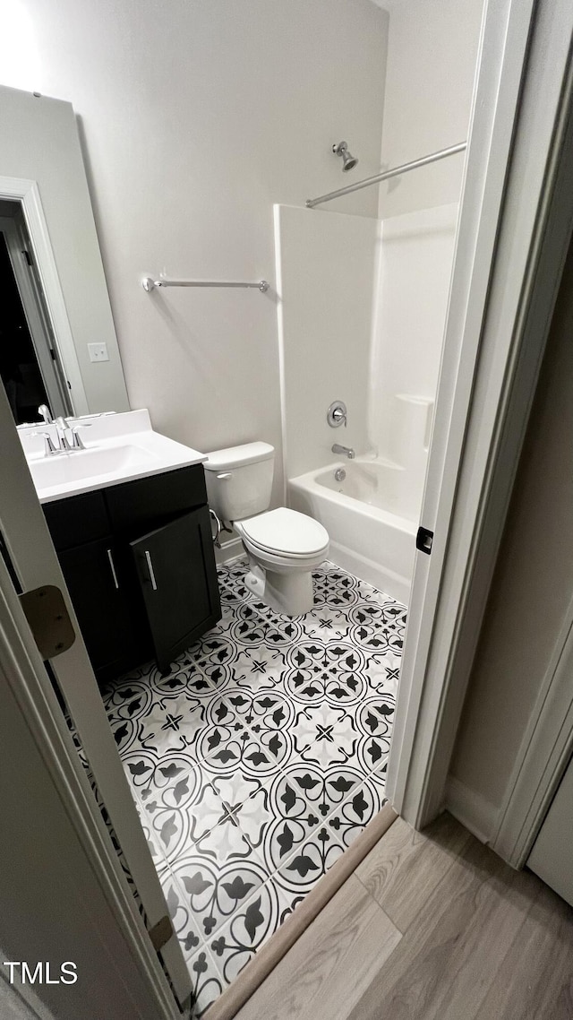 bathroom featuring shower / washtub combination, vanity, and toilet