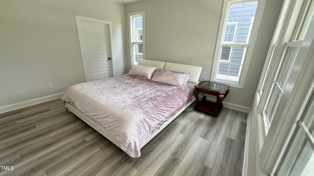 bedroom featuring baseboards and wood finished floors