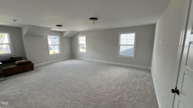 interior space featuring baseboards and light colored carpet