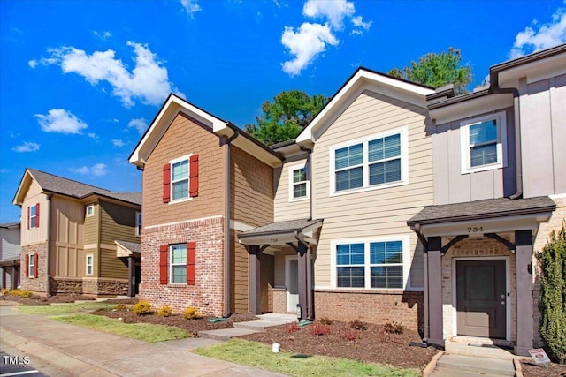 multi unit property featuring board and batten siding and brick siding