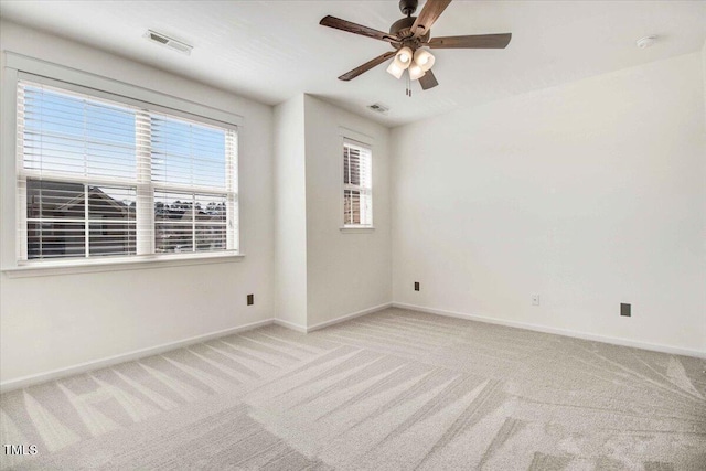 unfurnished room featuring light carpet, baseboards, and visible vents