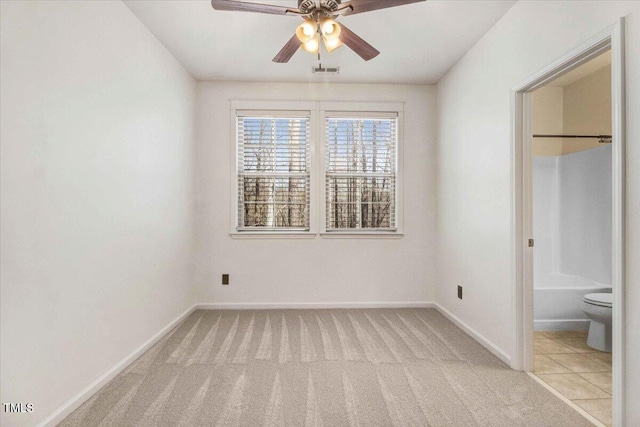 unfurnished bedroom featuring light carpet, ceiling fan, visible vents, and baseboards