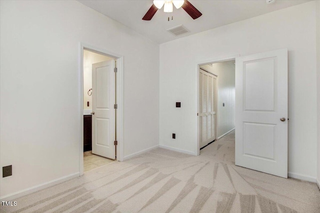 unfurnished bedroom featuring a ceiling fan, light colored carpet, visible vents, and baseboards