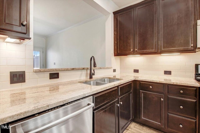 kitchen featuring a sink, light stone counters, dishwasher, and ornamental molding