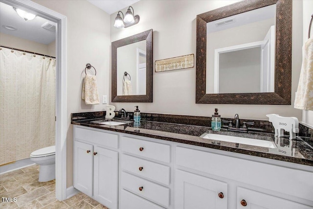 301 Stonebridge Dr, Pikeville, NC 27863 - bathroom featuring double vanity, visible vents, toilet, and a sink
