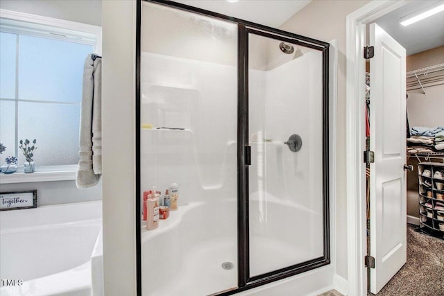 301 Stonebridge Dr, Pikeville, NC 27863 - bathroom featuring a spacious closet, a shower stall, and a bath