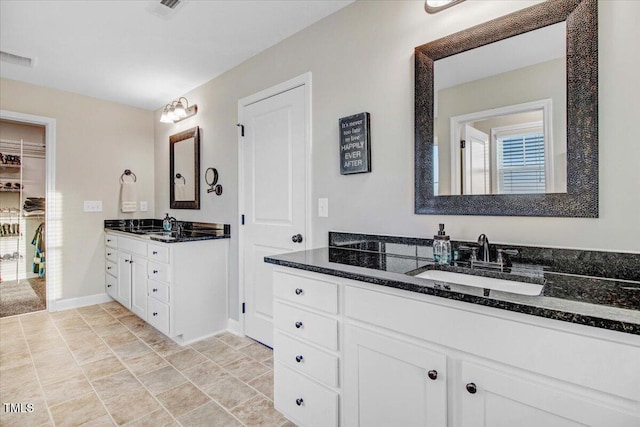 301 Stonebridge Dr, Pikeville, NC 27863 - full bath with two vanities, a sink, visible vents, and baseboards