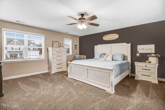 301 Stonebridge Dr, Pikeville, NC 27863 - bedroom featuring a ceiling fan, dark carpet, visible vents, and baseboards