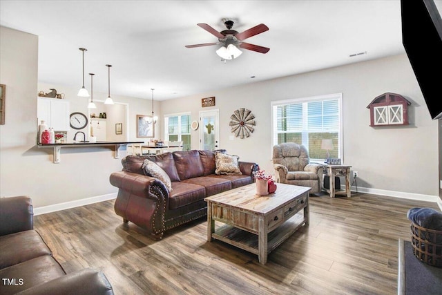 301 Stonebridge Dr, Pikeville, NC 27863 - living room featuring a ceiling fan, baseboards, and dark wood-type flooring