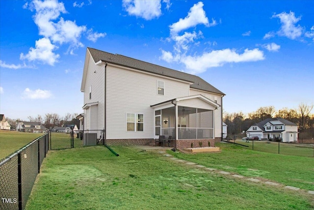 301 Stonebridge Dr, Pikeville, NC 27863 - back of house featuring a sunroom, a fenced backyard, a yard, and a gate
