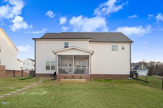301 Stonebridge Dr, Pikeville, NC 27863 - back of property featuring a sunroom, central AC, a lawn, and fence