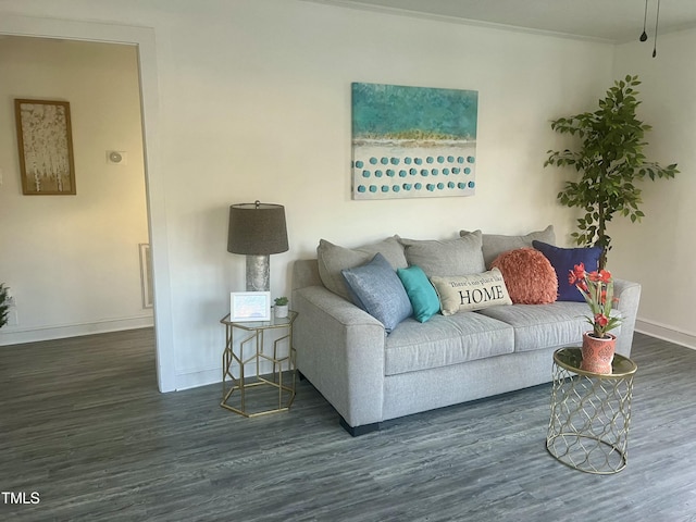 living area with baseboards and wood finished floors