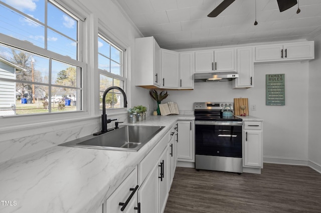kitchen with stainless steel range with electric cooktop, a ceiling fan, under cabinet range hood, white cabinetry, and a sink