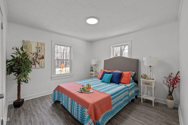 bedroom featuring baseboards and wood finished floors