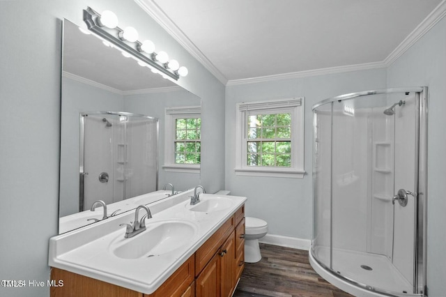 full bathroom featuring crown molding, wood finished floors, a sink, and a shower stall