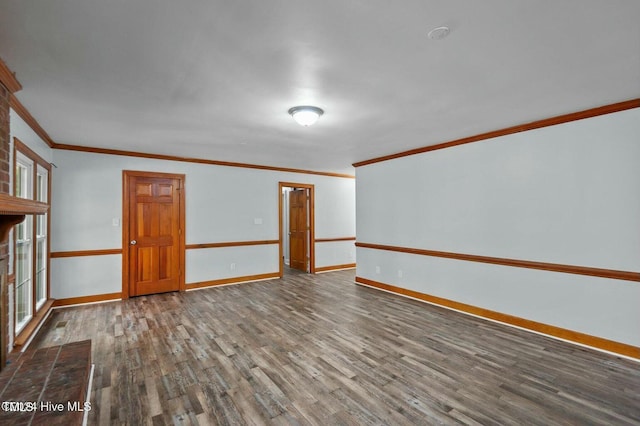 unfurnished room with baseboards, wood finished floors, and ornamental molding