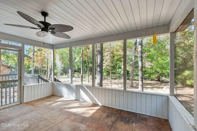 unfurnished sunroom with a ceiling fan and a healthy amount of sunlight