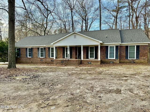 single story home featuring roof with shingles, brick siding, and crawl space