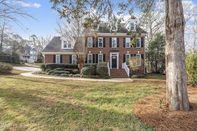 view of front of property featuring crawl space, brick siding, and a front lawn