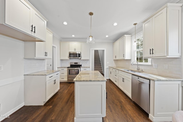 kitchen featuring stainless steel appliances, dark wood-type flooring, a sink, and white cabinetry