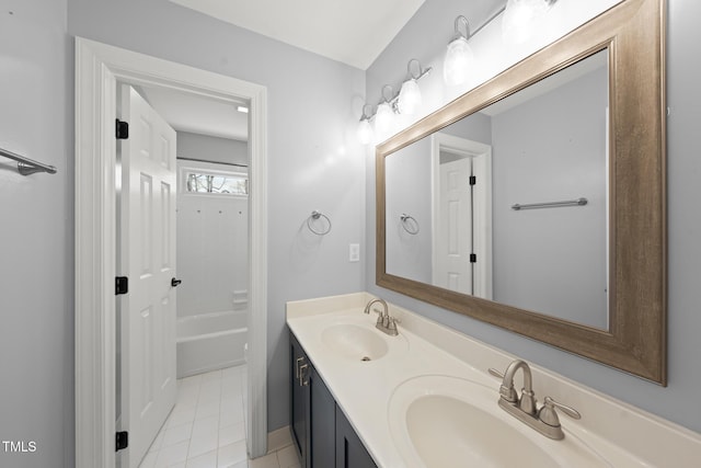 full bath with double vanity, tile patterned flooring, and a sink