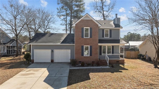 traditional-style home featuring an attached garage, covered porch, driveway, crawl space, and a chimney