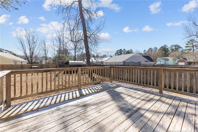 wooden terrace with a fenced backyard and a residential view