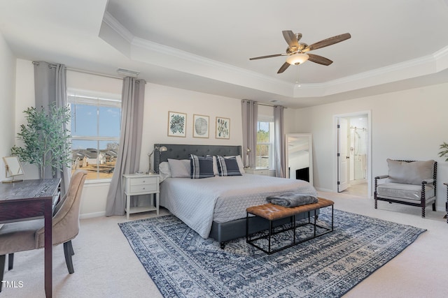 bedroom with light carpet, baseboards, a raised ceiling, and crown molding