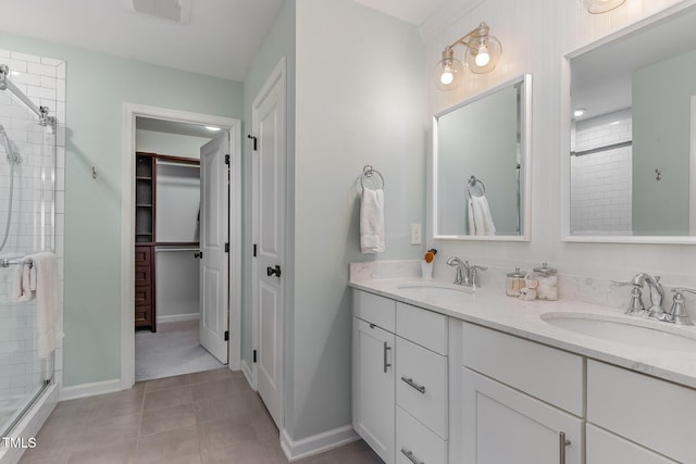 bathroom with a stall shower, a sink, visible vents, and a walk in closet