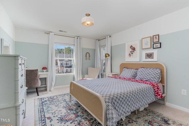 carpeted bedroom with visible vents and baseboards