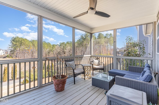 sunroom featuring ceiling fan