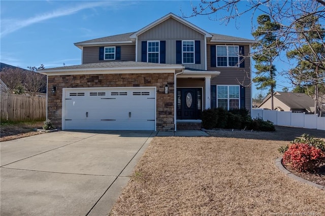 view of front facade with board and batten siding, stone siding, fence, and driveway