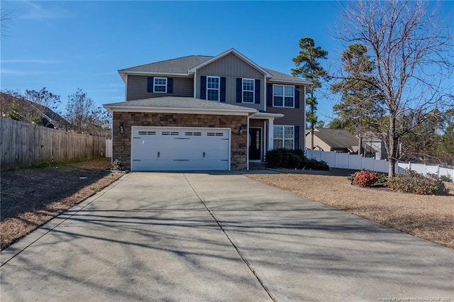 view of front facade with stone siding, fence, and driveway