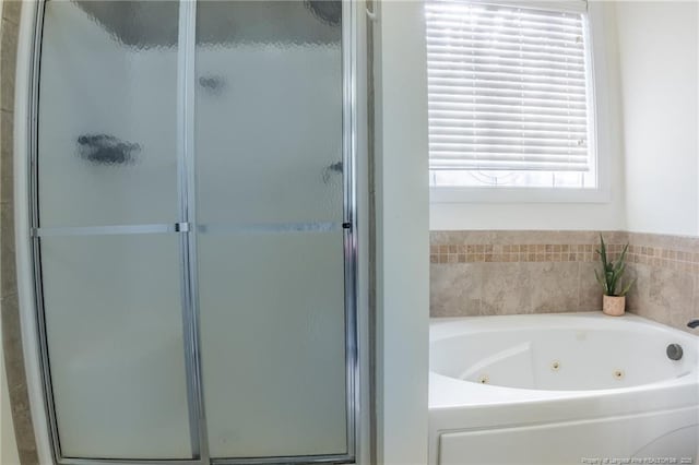 bathroom with a whirlpool tub and a stall shower