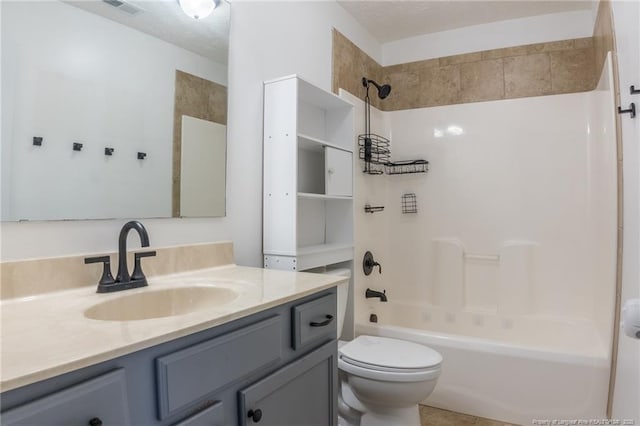 bathroom with shower / washtub combination, visible vents, vanity, and toilet