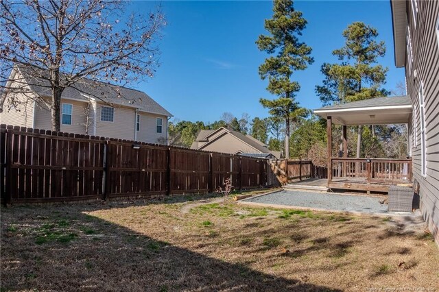 view of yard with a fenced backyard and a wooden deck