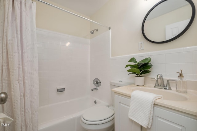 bathroom with shower / bath combo, toilet, a wainscoted wall, vanity, and tile walls