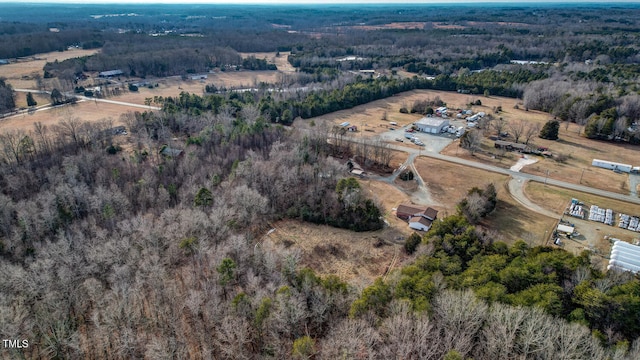 birds eye view of property featuring a wooded view