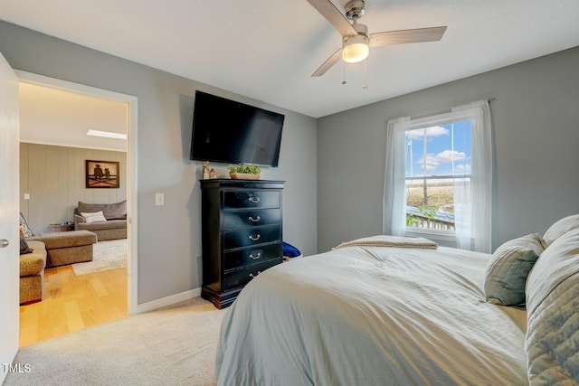 carpeted bedroom featuring a ceiling fan and baseboards