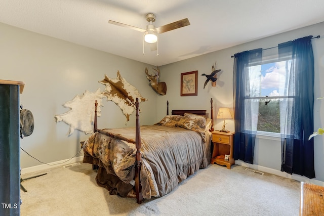 bedroom featuring ceiling fan, carpet flooring, visible vents, and baseboards