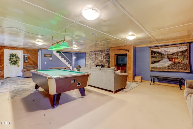 recreation room with concrete floors, billiards, and wooden walls