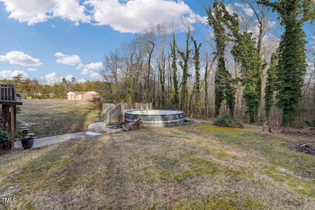 view of yard featuring an outdoor pool