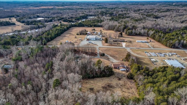 birds eye view of property featuring a view of trees