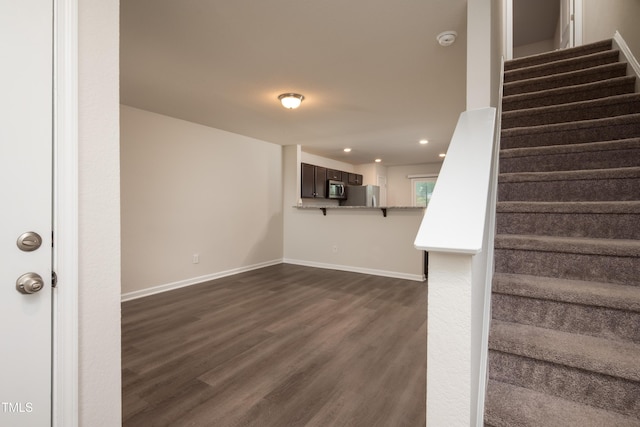 interior space featuring baseboards, wood finished floors, and recessed lighting